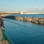 Italy, Napoli - A man fishes in the Mergellina bay Ph: Fabrizio Fiorenzano